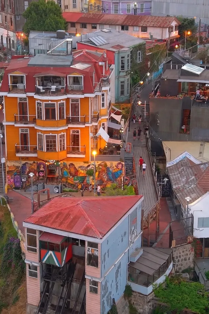 The yellow Casa Vander mansion on Cerro Alegre, next to the Reina Victoria funicular station, at sunset.
